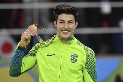 Brazils Arthur Mariano celebrates on the podium of the mens floor event final of the Artistic Gymnastics at the Olympic Arena during the Rio 2016 Olympic Games in Rio de Janeiro on August 14, 2016. 
Ben STANSALL / AFP