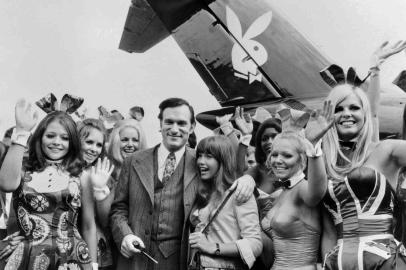 Hugh Hefner, with his then-girlfriend, actress Barbara Benton, and other playmates, arrives in Paris on the Playboy jet in 1970. Stringer/AFP

