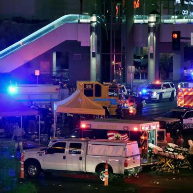 LAS VEGAS, NV - OCTOBER 02: Police and rescue personnel gather at the intersection of Las Vegas Boulevard and Tropicana Ave. after a mass shooting at a country music festival nearby on October 2, 2017 in Las Vegas, Nevada. A gunman has opened fire on a music festival in Las Vegas, leaving at least 50 people dead and more than 200 injured. Police have confirmed that one suspect, Stephen Paddock, has been shot and killed. The investigation is ongoing.   Ethan Miller/Getty Images/AFP