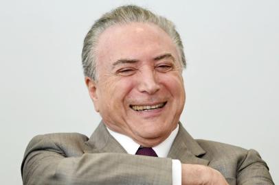 Brazilian President Michel Temer attends the launching ceremony of Progredir, a plan to create jobs and income, at Planalto Palace in Brasilia, on September 26, 2017.
Brazil's lower house of Congress began to analyze graft charges against President Michel Temer on Tuesday, a process that analysts believe will see him able to escape trial. In a first step expected to take several hours, the charges of racketeering and obstruction of justice were being read out to the lower chamber. / AFP PHOTO / EVARISTO SA