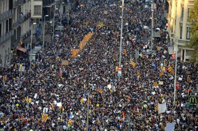 Protesters raise their hands as they gather during a general strike in Barcelona called by Catalan unions on October 3, 2017.Large numbers of Catalans are expected to observe a general strike today to condemn police violence at a banned weekend referendum on independence, as Madrid comes under growing international pressure to resolve its worst political crisis in decades. / AFP PHOTO / Josep LAGO