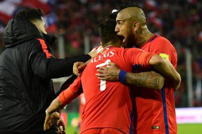 Chiles Alexis Sanchez (C) celebrates with teammate Arturo Vidal (R) after scoring against Ecuador during their 2018 World Cup qualifier football match in Santiago on October 5, 2017. / AFP PHOTO / Martin BERNETTI