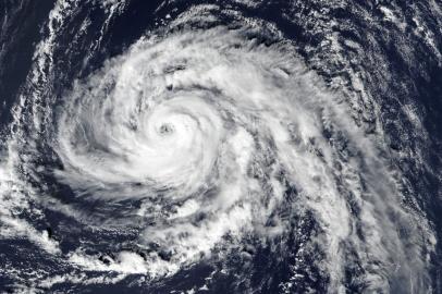 This handout satellite image captured on October 13, 2017 by the Visible Infrared Imaging Radiometer Suite (VIIRS) on the Suomi NPP and released by NASA Earth Observatory on October 15, 2017 shows hurricane Ophelia approaching the Azores islands in the Atlantic Ocean. Hurricane Ophelia strengthened to a Category 3 storm as it passed near the Portuguese Azores archipelago on Octoer 14 on route for Ireland. Five counties in the west of Ireland will be placed on red alert for "severe" weather conditions from October 16 morning to early October 17, the Irish Meteorological Service said.