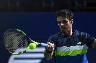 Brazils Rogerio Dutra Silva returns the ball to Russias Evgeny Donskoy during their tennis match at the Kremlin Cup tennis tournament in Moscow on October 17, 2017. / AFP PHOTO / Yuri KADOBNOV