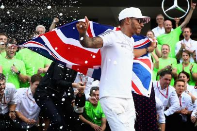 MEXICO CITY, MEXICO - OCTOBER 29: Lewis Hamilton of Great Britain and Mercedes GP celebrates after winning his fourth F1 World Drivers Championship after the Formula One Grand Prix of Mexico at Autodromo Hermanos Rodriguez on October 29, 2017 in Mexico City, Mexico.   Clive Mason/Getty Images/AFP