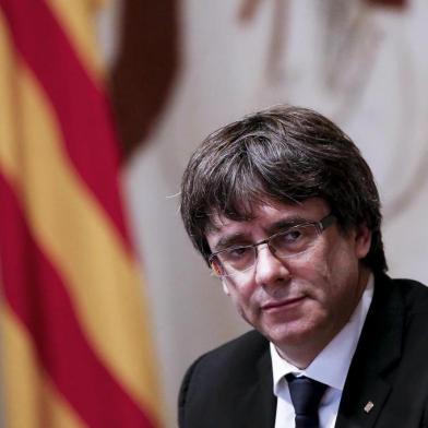 Catalan regional government president Carles Puigdemont attends a regional government meeting at the Generalitat Palace in Barcelona on October 10, 2017. 
Spains worst political crisis in a generation will come to a head as Catalonias leader could declare independence from Madrid in a move likely to send shockwaves through Europe.  / AFP PHOTO / PAU BARRENA