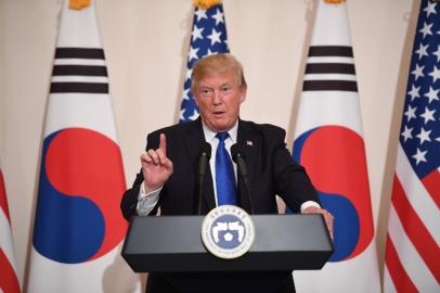 US President Donald Trump gestures during a joint press conference with South Korea's President Moon Jae-In at the presidential Blue House in Seoul on November 7, 2017. US President Donald Trump arrived in Seoul on November 7 vowing to "figure it all out" with his South Korean counterpart Moon Jae-In, despite the two allies' differences on how to deal with the nuclear-armed North. Jim WATSON / AFP