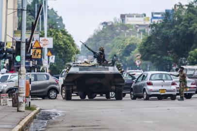 An armoured personnel carrier stations by an intersection as Zimbabwean soldiers regulate traffic in Harare on November 15, 2017. Zimbabwe's military appeared to be in control of the country on November 15 as generals denied staging a coup but used state television to vow to target "criminals" close to President Mugabe.