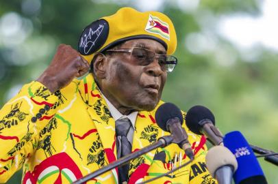 (FILES) This file photo taken on November 08, 2017 shows Zimbabwes President Robert Mugabe addressing party members and supporters gathered at his party headquarters to show support to Grace Mugabe becoming the partys next Vice President after the dismissal of Emerson Mnangagwa.
Zimbabwes military appeared to be in control of the country on November 15, 2017 as generals denied staging a coup but used state television to vow to target criminals close to President Robert Mugabe. / AFP PHOTO / Jekesai NJIKIZANA