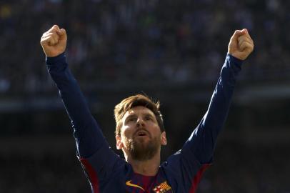 Barcelonas Argentinian forward Lionel Messi celebrates after scoring during the Spanish League Clasico football match Real Madrid CF vs FC Barcelona at the Santiago Bernabeu stadium in Madrid on December 23, 2017.  / AFP PHOTO / CURTO DE LA TORRE