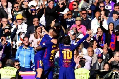 Barcelonas Argentinian forward Lionel Messi (R) celebrates after scoring during the Spanish League Clasico football match Real Madrid CF vs FC Barcelona at the Santiago Bernabeu stadium in Madrid on December 23, 2017.  / AFP PHOTO / JAVIER SORIANO