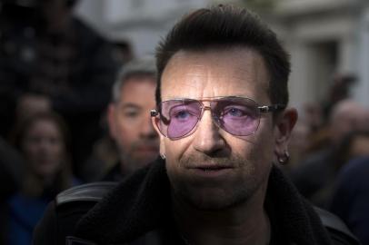 U2 frontman Bono arrives at a west London studio to record the new Band Aid 30 single on November 15, 2014. Bob Geldof, One Direction, Bono and some 30 other stars gathered in a studio in London on Saturday to record a 30th anniversary version of the Band Aid charity single to raise money to fight Ebola. Led Zeppelin's Robert Plant, Coldplay's Chris Martin and Sinead O'Connor were also among the rockers brought together by Geldof to sing the fourth version of "Do They Know It's Christmas?" Musicians began arriving in the early morning and were expected to record all day and into the night before the single is aired for the first time on Sunday and then officially released on Monday. AFP PHOTO / ANDREW COWIE