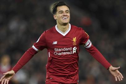 Liverpools Brazilian midfielder Philippe Coutinho celebrates scoring the opening goal of the English Premier League football match between Liverpool and Swansea City at Anfield in Liverpool, north west England on December 26, 2017. / AFP PHOTO / Paul ELLIS / RESTRICTED TO EDITORIAL USE. No use with unauthorized audio, video, data, fixture lists, club/league logos or live services. Online in-match use limited to 75 images, no video emulation. No use in betting, games or single club/league/player publications.  / 