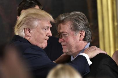 (FILES) This file photo taken on January 22, 2017 shows US President Donald Trump (L) congratulating Senior Counselor to the President Stephen Bannon during the swearing-in of senior staff in the East Room of the White House on January 22, 2017 in Washington, DC.Steve Bannon, President Donald Trump's chief strategist, has lost his seat on the powerful National Security Council on April 05, 2017 in an apparent high-level shakeup, a US official confirmed. / AFP PHOTO / MANDEL NGAN