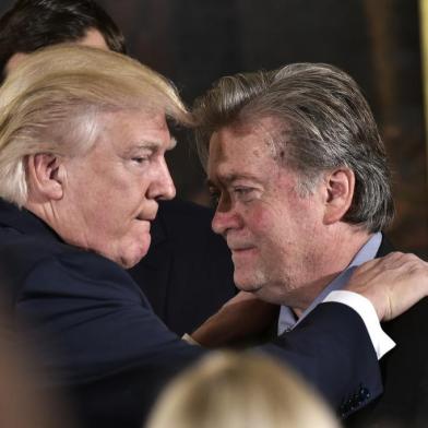 (FILES) This file photo taken on January 22, 2017 shows US President Donald Trump (L) congratulating Senior Counselor to the President Stephen Bannon during the swearing-in of senior staff in the East Room of the White House on January 22, 2017 in Washington, DC.Steve Bannon, President Donald Trumps chief strategist, has lost his seat on the powerful National Security Council on April 05, 2017 in an apparent high-level shakeup, a US official confirmed. / AFP PHOTO / MANDEL NGAN