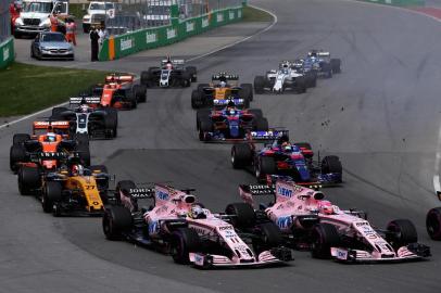 MONTREAL, QC - JUNE 11: Esteban Ocon of France driving the (31) Sahara Force India F1 Team VJM10 and Sergio Perez of Mexico driving the (11) Sahara Force India F1 Team VJM10 battle for position into turn 1 at the start during the Canadian Formula One Grand Prix at Circuit Gilles Villeneuve on June 11, 2017 in Montreal, Canada.   Mark Thompson/Getty Images/AFP