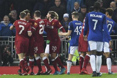 Liverpools Brazilian midfielder Roberto Firmino (L) is restrained by team-mates as he reacts after Evertons English defender Mason Holgate (R) pushed him in a challenge resulting in Firmino falling into the crowd during the English FA Cup third round football match between Liverpool and Everton at Anfield in Liverpool, north west England on January 5, 2018. / AFP PHOTO / Paul ELLIS / RESTRICTED TO EDITORIAL USE. No use with unauthorized audio, video, data, fixture lists, club/league logos or live services. Online in-match use limited to 75 images, no video emulation. No use in betting, games or single club/league/player publications.  / 