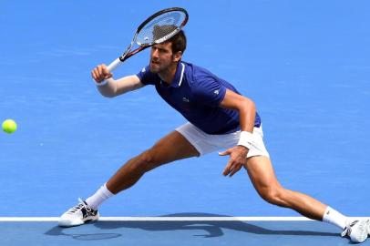 Novak Djokovic of Serbia hits a return during his match against Dominic Thiem of Austria at Kooyong Classic tennis tournament in Melbourne on January 10, 2018. / AFP PHOTO / William WEST / -- IMAGE RESTRICTED TO EDITORIAL USE - STRICTLY NO COMMERCIAL USE --