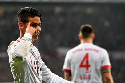 Bayern Munichs midfielder James Rodriguez celebrates after scoring during the German First division Bundesliga football match Bayer Leverkusen vs FC Bayern Munich on January 12, 2018 in Leverkusen, western Germany. / AFP PHOTO / SASCHA SCHUERMANN / RESTRICTIONS: DURING MATCH TIME: DFL RULES TO LIMIT THE ONLINE USAGE TO 15 PICTURES PER MATCH AND FORBID IMAGE SEQUENCES TO SIMULATE VIDEO. == RESTRICTED TO EDITORIAL USE == FOR FURTHER QUERIES PLEASE CONTACT DFL DIRECTLY AT + 49 69 650050