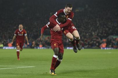 Liverpools Senegalese midfielder Sadio Mane (L) celebrates scoring their third goal to extend their lead 3-1 with Liverpools Scottish defender Andrew Robertson (R) during the English Premier League football match between Liverpool and Manchester City at Anfield in Liverpool, north west England on January 14, 2018. / AFP PHOTO / Oli SCARFF / RESTRICTED TO EDITORIAL USE. No use with unauthorized audio, video, data, fixture lists, club/league logos or live services. Online in-match use limited to 75 images, no video emulation. No use in betting, games or single club/league/player publications.  / 