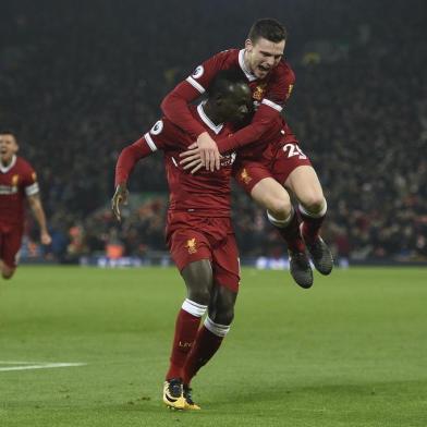 Liverpools Senegalese midfielder Sadio Mane (L) celebrates scoring their third goal to extend their lead 3-1 with Liverpools Scottish defender Andrew Robertson (R) during the English Premier League football match between Liverpool and Manchester City at Anfield in Liverpool, north west England on January 14, 2018. / AFP PHOTO / Oli SCARFF / RESTRICTED TO EDITORIAL USE. No use with unauthorized audio, video, data, fixture lists, club/league logos or live services. Online in-match use limited to 75 images, no video emulation. No use in betting, games or single club/league/player publications.  / 