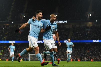 Manchester Citys Argentinian striker Sergio Aguero (L) celebrates with Manchester Citys Brazilian midfielder Fernandinho after scoring his and Manchester Citys third goal during the English Premier League football match between Manchester City and Newcastle United at the Etihad Stadium in Manchester, north west England, on January 20, 2018. / AFP PHOTO / Oli SCARFF / RESTRICTED TO EDITORIAL USE. No use with unauthorized audio, video, data, fixture lists, club/league logos or live services. Online in-match use limited to 75 images, no video emulation. No use in betting, games or single club/league/player publications.  / 