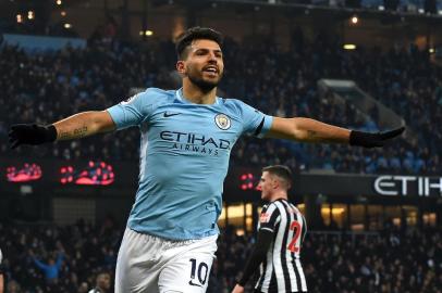 Manchester Citys Argentinian striker Sergio Aguero celebrates after scoring the opening goal of the English Premier League football match between Manchester City and Newcastle United at the Etihad Stadium in Manchester, north west England, on January 20, 2018. / AFP PHOTO / PAUL ELLIS / RESTRICTED TO EDITORIAL USE. No use with unauthorized audio, video, data, fixture lists, club/league logos or live services. Online in-match use limited to 75 images, no video emulation. No use in betting, games or single club/league/player publications.  / 