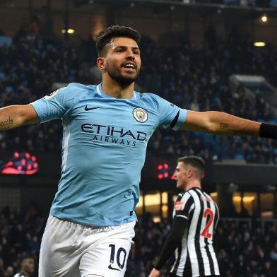 Manchester Citys Argentinian striker Sergio Aguero celebrates after scoring the opening goal of the English Premier League football match between Manchester City and Newcastle United at the Etihad Stadium in Manchester, north west England, on January 20, 2018. / AFP PHOTO / PAUL ELLIS / RESTRICTED TO EDITORIAL USE. No use with unauthorized audio, video, data, fixture lists, club/league logos or live services. Online in-match use limited to 75 images, no video emulation. No use in betting, games or single club/league/player publications.  / 