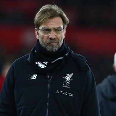 Liverpools German manager Jurgen Klopp checks out the pitch conditions ahead of the English Premier League football match between Swansea City and Liverpool at The Liberty Stadium in Swansea, south Wales on January 22, 2018. / AFP PHOTO / Geoff CADDICK / RESTRICTED TO EDITORIAL USE. No use with unauthorized audio, video, data, fixture lists, club/league logos or live services. Online in-match use limited to 75 images, no video emulation. No use in betting, games or single club/league/player publications.  / 