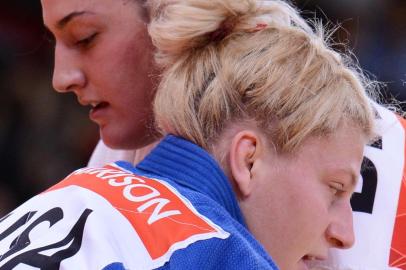 Brazis Mayra Aguiar (white) competes with United States Kayla Harrison (blue) during their womens -78kg judo contest semi-final match of the London 2012 Olympic Games on August 2, 2012 at the ExCel arena in London. AFP PHOTO / FRANCK FIFE