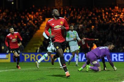 Manchester Uniteds Belgian striker Romelu Lukaku (C) reacts after scoring their fourth goal during the FA Cup fourth round football match between Yeovil Town and Manchester United at Huish Park in Yeovil, Somerset on January 26, 2018. / AFP PHOTO / - / RESTRICTED TO EDITORIAL USE. No use with unauthorized audio, video, data, fixture lists, club/league logos or live services. Online in-match use limited to 75 images, no video emulation. No use in betting, games or single club/league/player publications.  / 