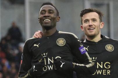 Leicester Citys Nigerian midfielder Wilfred Ndidi (L) celebrates scoring their fifth goal during the English FA Cup fourth round football match between Peterborough United and Leicester City at London Road stadium in Peterborough, eastern England, on January 27, 2018. / AFP PHOTO / Lindsey PARNABY / RESTRICTED TO EDITORIAL USE. No use with unauthorized audio, video, data, fixture lists, club/league logos or live services. Online in-match use limited to 75 images, no video emulation. No use in betting, games or single club/league/player publications.  / 