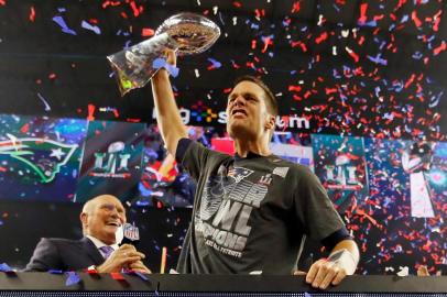 HOUSTON, TX - FEBRUARY 05: Tom Brady #12 of the New England Patriots celebrates with the Vince Lombardi Trophy after defeating the Atlanta Falcons during Super Bowl 51 at NRG Stadium on February 5, 2017 in Houston, Texas. The Patriots defeated the Falcons 34-28.   Kevin C. Cox/Getty Images/AFP