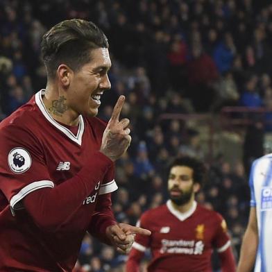 Liverpools Brazilian midfielder Roberto Firmino celebrates scoring their second goal during the English Premier League football match between Huddersfield Town and Liverpool at the John Smiths stadium in Huddersfield, northern England on January 30, 2018. / AFP PHOTO / PAUL ELLIS / RESTRICTED TO EDITORIAL USE. No use with unauthorized audio, video, data, fixture lists, club/league logos or live services. Online in-match use limited to 75 images, no video emulation. No use in betting, games or single club/league/player publications.  / 