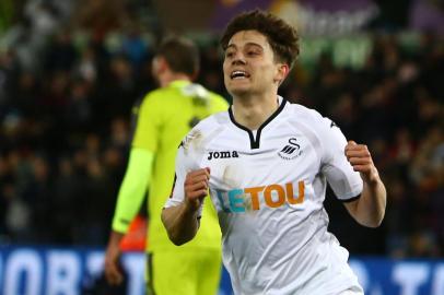 Swansea Citys Welsh midfielder Daniel James celebrates after scoring their eighth goal during the English FA Cup fourth round replay football match between Swansea City and Notts County at The Liberty Stadium in Swansea, south Wales on February 6, 2018. / AFP PHOTO / Geoff CADDICK / RESTRICTED TO EDITORIAL USE. No use with unauthorized audio, video, data, fixture lists, club/league logos or live services. Online in-match use limited to 75 images, no video emulation. No use in betting, games or single club/league/player publications.  / 