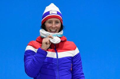 Norways Marit Bjoergen celebrates on the podium during the medal ceremony after taking the second place in the womens 7.5km + 7.5km cross-country skiathlon event at the Pyeongchang Medals Plaza during the Pyeongchang 2018 Winter Olympic Games on February 10, 2018 in Pyeongchang.  / AFP PHOTO / JAVIER SORIANO