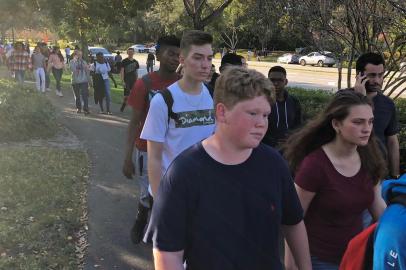 Students leave Marjory Stoneman Douglas High School in Parkland, Florida, a city about 50 miles (80 kilometers) north of Miami on February 14, 2018 following a school shooting.A gunman opened fire at the Florida high school, an incident that officials said caused numerous fatalities and left terrified students huddled in their classrooms, texting friends and family for help.The Broward County Sheriffs Office said a suspect was in custody. / AFP PHOTO / Michele Eve SANDBERG / The erroneous mention[s] appearing in the metadata of this photo by Michele Eve SANDBERG has been modified in AFP systems in the following manner: [Byline: Michele Eve SANDBERG] instead of [Eva Hambach]. Please immediately remove the erroneous mention from all your online services and delete it from your servers. If you have been authorized by AFP to distribute it to third parties, please ensure that the same actions are carried out by them. Failure to promptly comply with these instructions will entail liability on your part for any continued or post notification usage. Therefore we thank you very much for all your attention and prompt action. We are sorry for the inconvenience this notification may cause and remain at your disposal for any further information you may require.