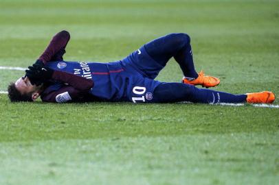 Paris Saint-Germains Brazilian forward Neymar Jr reacts lying on the pitch during the French L1 football match between Paris Saint-Germain (PSG) and Marseille (OM) at the Parc des Princes in Paris on February 25, 2018.  / AFP PHOTO / GEOFFROY VAN DER HASSELT