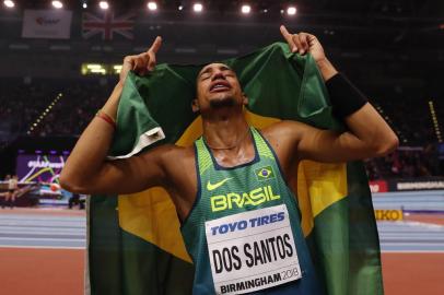 Brazil's Almir dos Santos celebrates taking silver in the men's triple jump final at the 2018 IAAF World Indoor Athletics Championships at the Arena in Birmingham on March 3, 2018. / AFP PHOTO / Adrian DENNIS