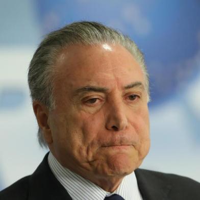 Brazilian President Michel Temer gestures during a press conference where he announced the schedule for some workers to withdraw money from their PIS/Pasep social programme funds, in an attempt to boost the countrys economy, at Planalto Palace in Brasilia, on September 28, 2017.   / AFP PHOTO / Sergio LIMA