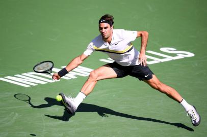 INDIAN WELLS, CA - MARCH 12: Roger Federer of Switzerland attempts a running forehand in his match against Filip Krajinovic of Serbia during the BNP Paribas Open at the Indian Wells Tennis Garden on March 12, 2018 in Indian Wells, California.   Harry How/Getty Images/AFP