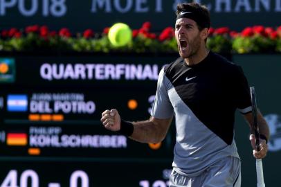 INDIAN WELLS, CA - MARCH 16: Juan Martin Del Potro of Argentina reacts to match point over Philipp Kohlschreiber of Germany during the BNP Paribas Open at the Indian Wells Tennis Garden on March 16, 2018 in Indian Wells, California.   Harry How/Getty Images/AFP