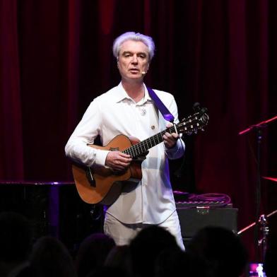 (FILES) In this file photo taken on May 11, 2017 David Byrne performs onstage during the WITNESS 25th Anniversary Gala at The Edison Ballroom in New York City.   David Byrne, an underground icon since the 1970s, has earned his first Top 10 album in the United States with his latest work, American Utopia. The album debuted at number three on the Billboard chart, selling 63,000 copies in the week through March 15, 2018, tracking service Nielsen Music said.Nielsen attributed the success in part to a bundling arrangement that sees fans buy the album as part of a package with tickets to Byrnes tour. / AFP PHOTO / GETTY IMAGES NORTH AMERICA / Dia Dipasupil