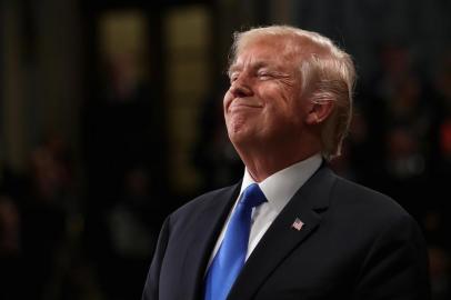 US President Donald Trump smiles during the State of the Union address in the chamber of the US House of Representatives on January 30, 2018 in Washington, DC.  / AFP PHOTO / POOL / Win McNamee