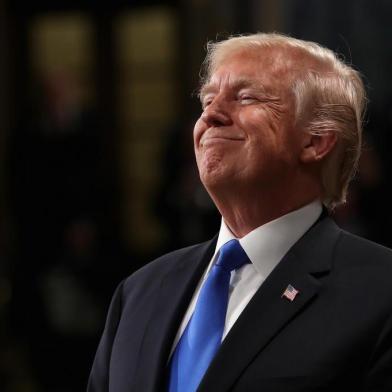 US President Donald Trump smiles during the State of the Union address in the chamber of the US House of Representatives on January 30, 2018 in Washington, DC.  / AFP PHOTO / POOL / Win McNamee