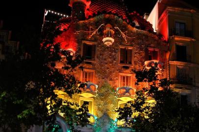 Picture shows the The Casa Batllo, designed by Spanish architect Antoni Gaudi, illuminated with the rainbow colours in Barcelona, on June 28, 2017. / AFP PHOTO / LLUIS GENE