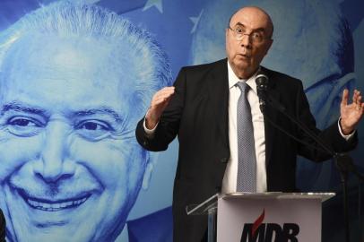 Brazils Finance Minister Henrique Meirelles delivers a speech after affiliating to the Brazilian Democratic Movement (MDB) party, at the partys headquarters in Brasilia, on April 3, 2018. / AFP PHOTO / EVARISTO SA