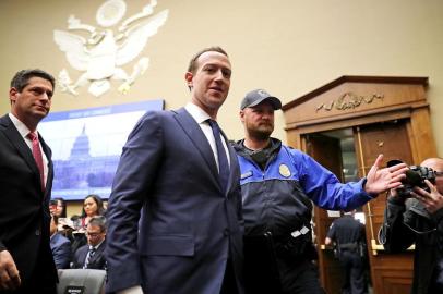 Facebook CEO Mark Zuckerberg Testifies At House HearingWASHINGTON, DC - APRIL 11: Facebook co-founder, Chairman and CEO Mark Zuckerberg (C) leaves during a break in a hearing of the House Energy and Commerce Committee in the Rayburn House Office Building on Capitol Hill April 11, 2018 in Washington, DC. This is the second day of testimony before Congress by Zuckerberg, 33, after it was reported that 87 million Facebook users had their personal information harvested by Cambridge Analytica, a British political consulting firm linked to the Trump campaign.   Chip Somodevilla/Getty Images/AFPEditoria: POLLocal: WashingtonIndexador: CHIP SOMODEVILLASecao: GovernmentFonte: GETTY IMAGES NORTH AMERICAFotógrafo: STF