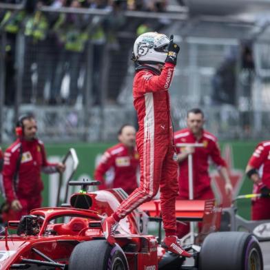 Ferraris German driver Sebastian Vettel reacts after qualifying in pole position for the Formula One Chinese Grand Prix in Shanghai on April 14, 2018.  / AFP PHOTO / Johannes EISELE