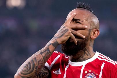 Bayern Munichs Chilian midfielder Arturo Vidal celebrates after scoring during the German first division Bundesliga football match, Bayern Munich v TSG 1899 Hoffenheim, on January 27, 2018 in Munich, southern Germany. / AFP PHOTO / DPA / Sven Hoppe / Germany OUT / RESTRICTIONS: DURING MATCH TIME: DFL RULES TO LIMIT THE ONLINE USAGE TO 15 PICTURES PER MATCH AND FORBID IMAGE SEQUENCES TO SIMULATE VIDEO. == RESTRICTED TO EDITORIAL USE == FOR FURTHER QUERIES PLEASE CONTACT DFL DIRECTLY AT + 49 69 650050 